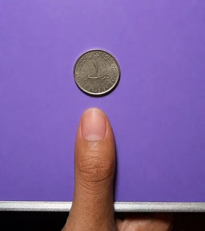 Single finger with coin for nail sizing