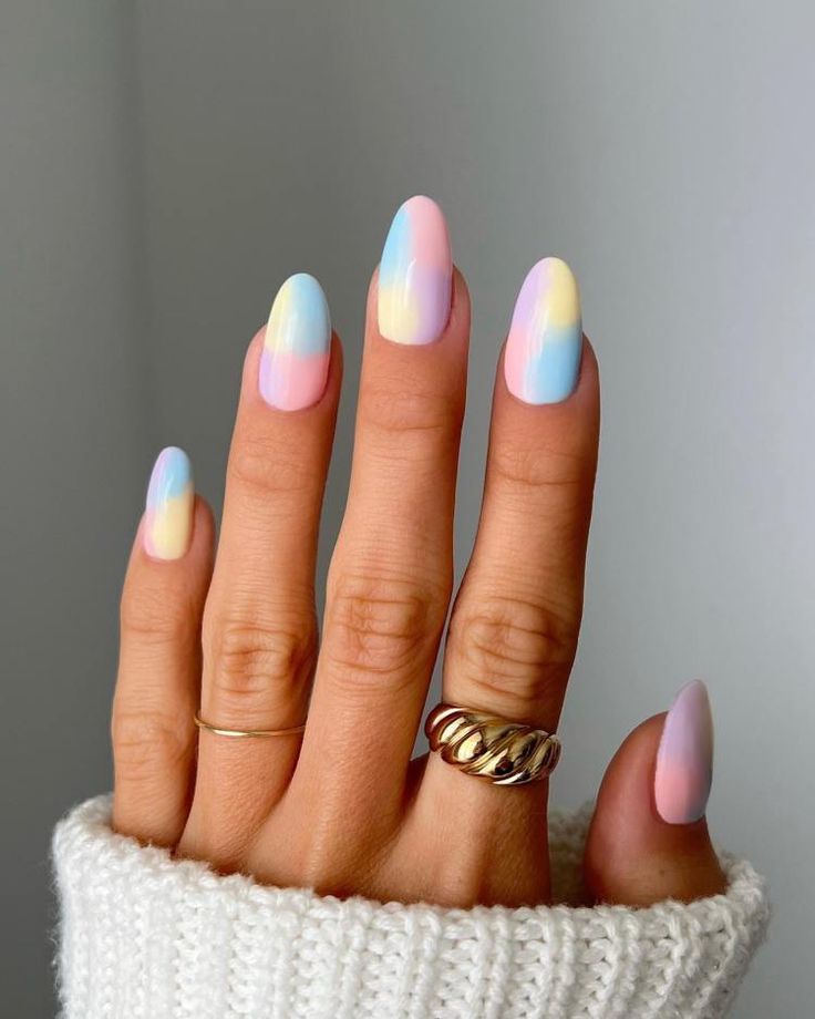 a fem ale hand with tie and dye gradient easter style nails