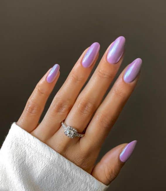 female hands with glazed donut purple nails