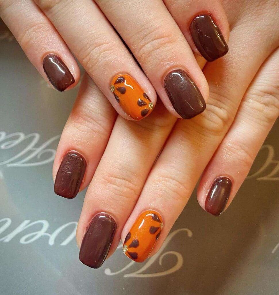 A display of brown and orange thanksgiving nails with flower pattern x Copy