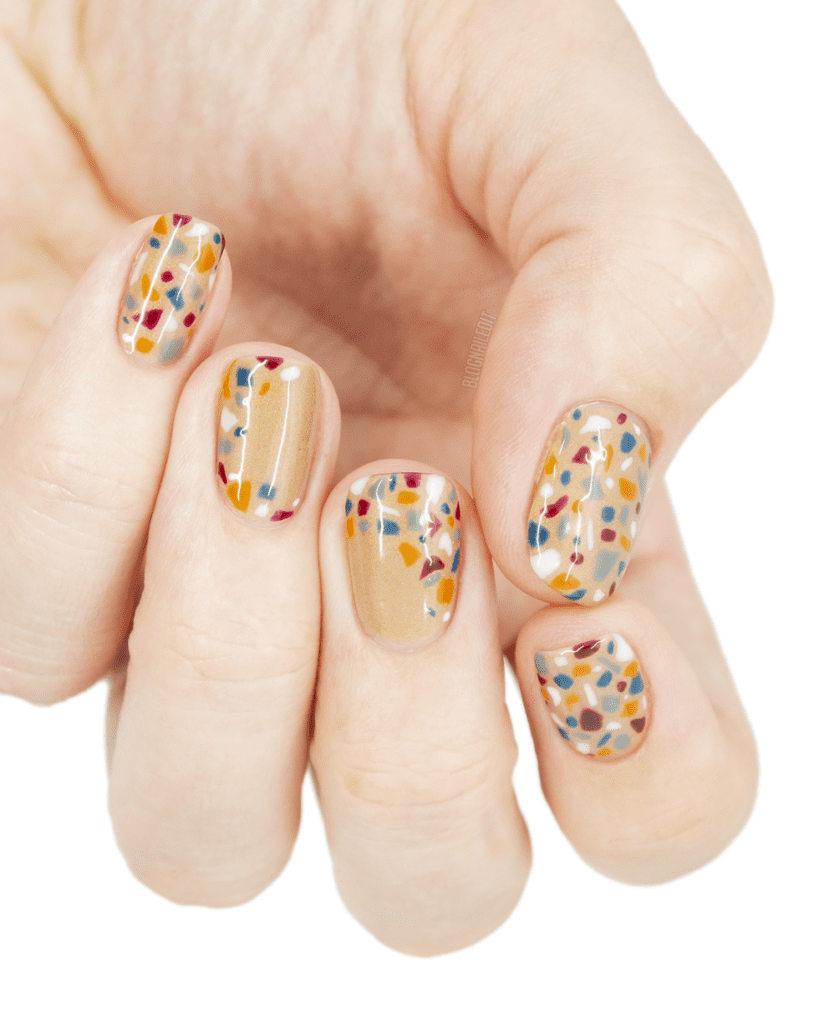 A hand displaying a neutral color Terrazzo Tile Nails for Thanksgiving x