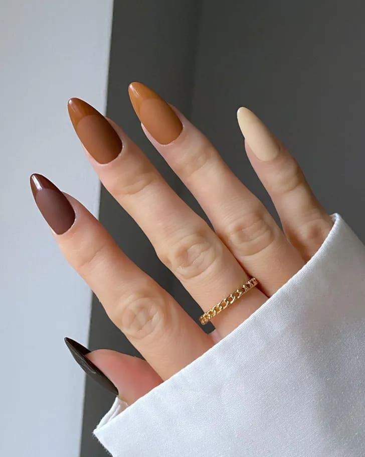 A hand displaying brown matte nails