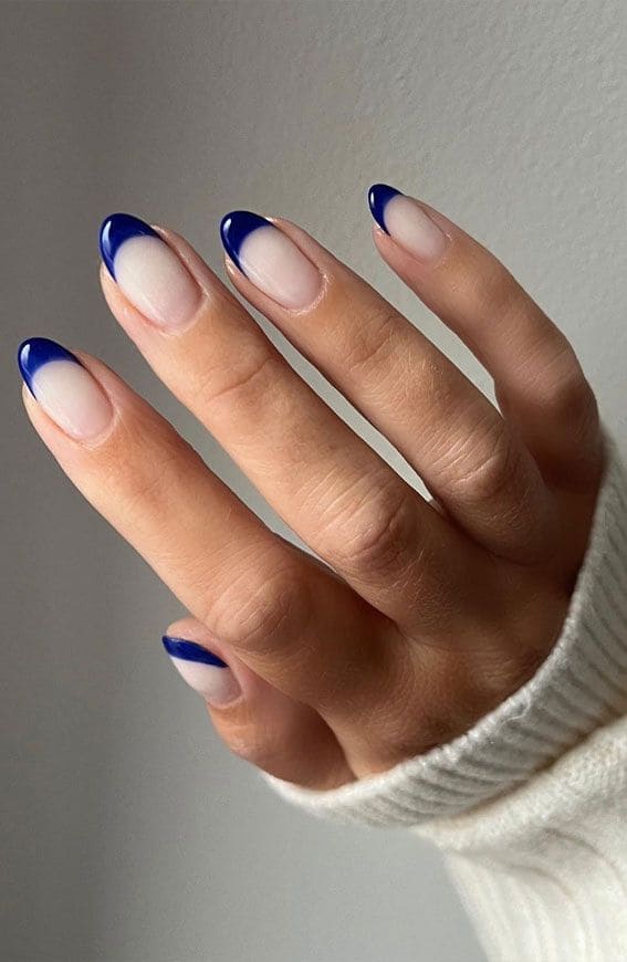 A view of hands with dark blue nail tips