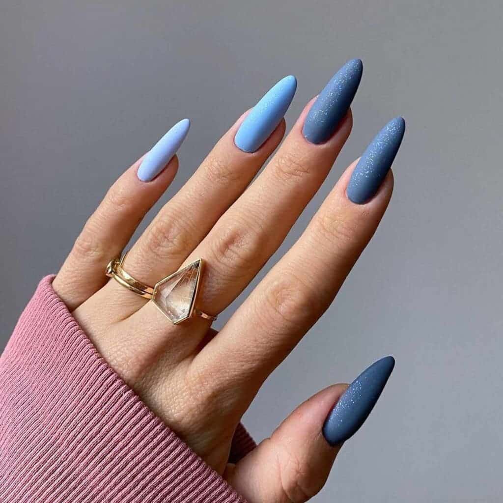 A view of matte ombre nails with different shades of blue x