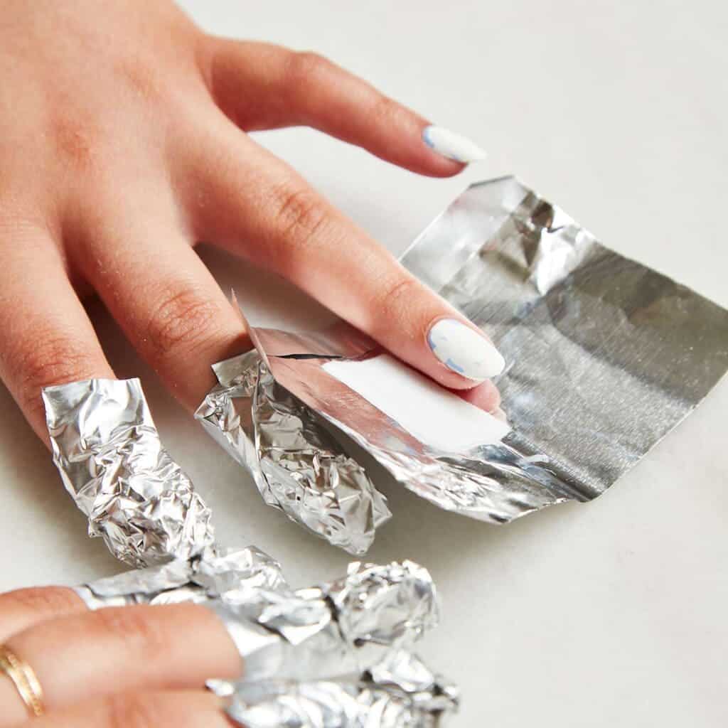 A view of nails covered in foil for removal of polygel nails x