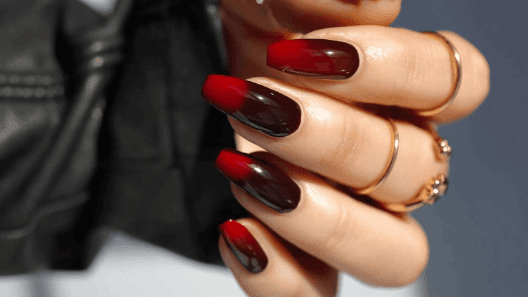 A view of nails showing dark burgundy maroon and black gothic nails