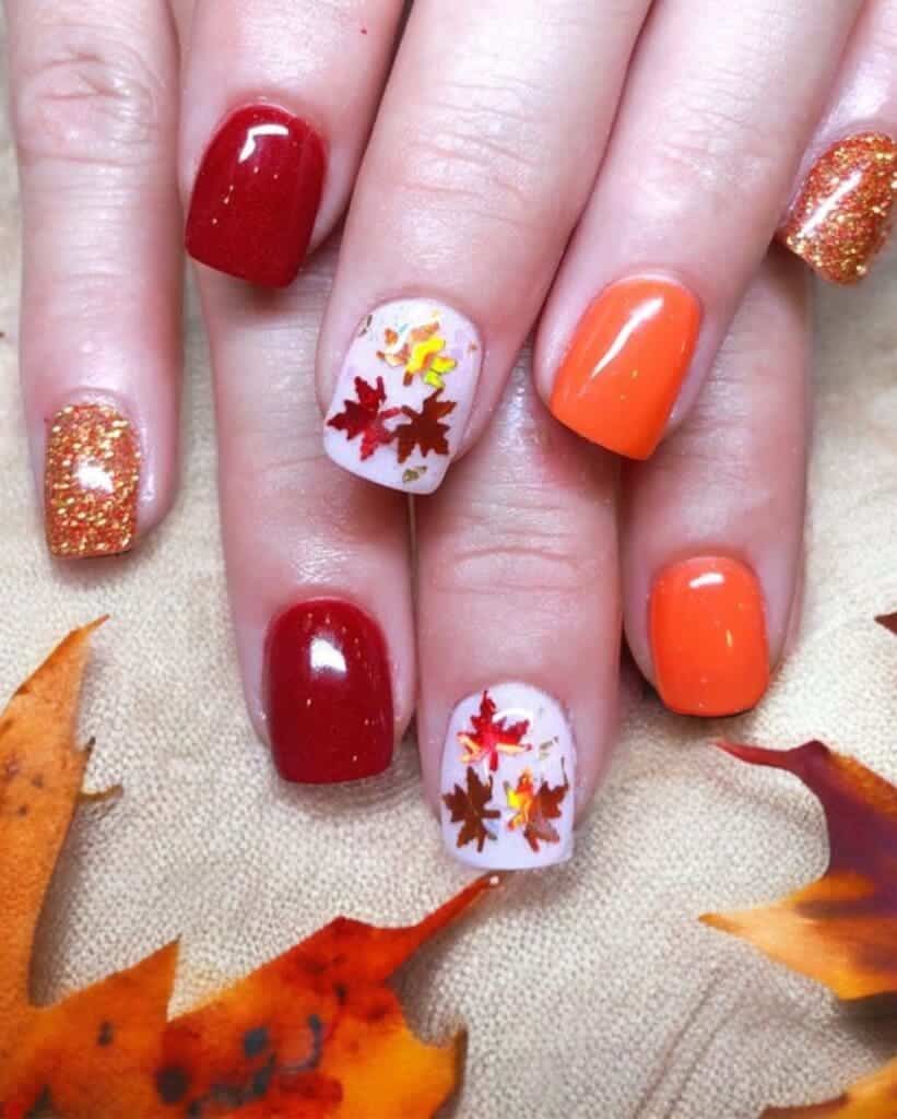 A view of red and orange glittery fall leaves nail designs x