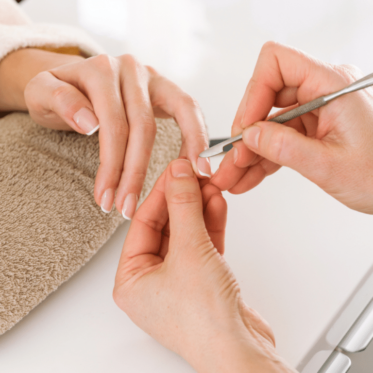a nail stylist is removing nail glue from the cleints nails