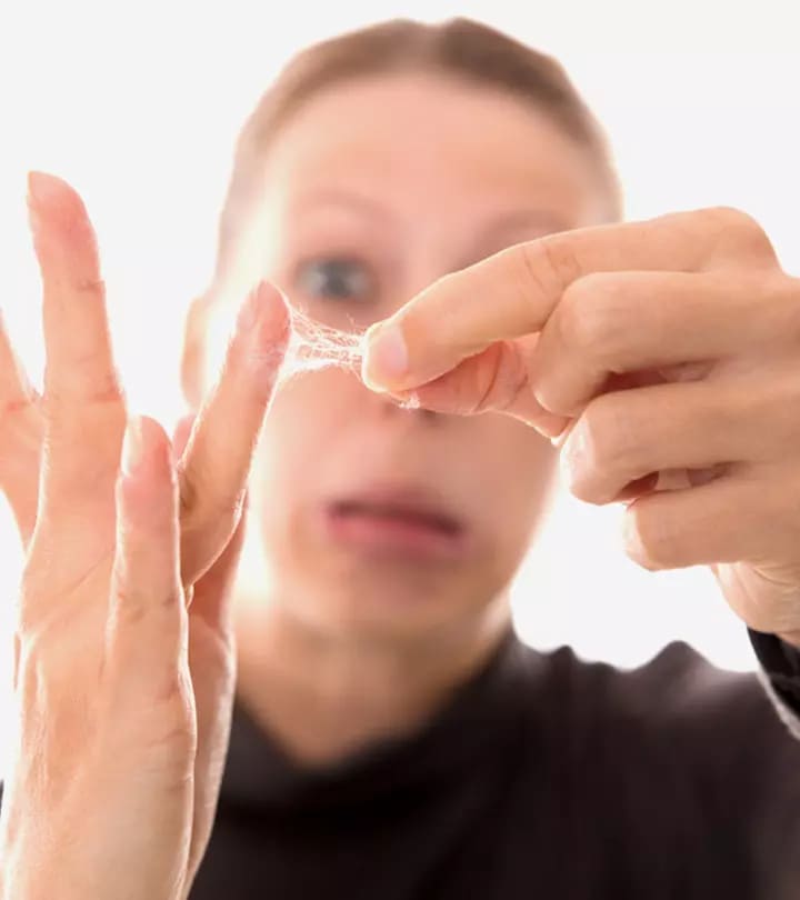 a women is removing nail glue from her skin