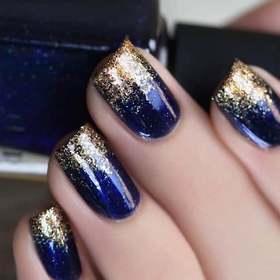 blue volor nail art with golden glitter chunks blue volor nail art with golden glitter chunks