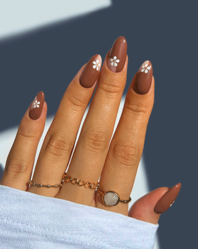brown nails with floral patterns girl wearing rings brown nails with floral patterns girl wearing rings