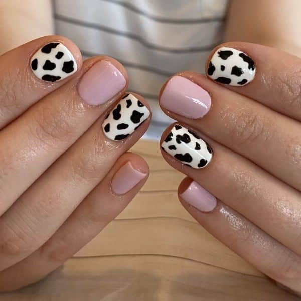 cow print short nails with pink contrast on some nails cow print short nails with pink contrast on some nails