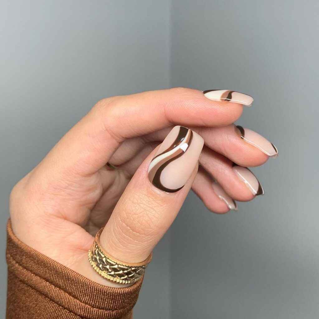 girls hand with simple nails and chocolate brown swirls on them x zon girls hand with simple nails and chocolate brown swirls on them x zon
