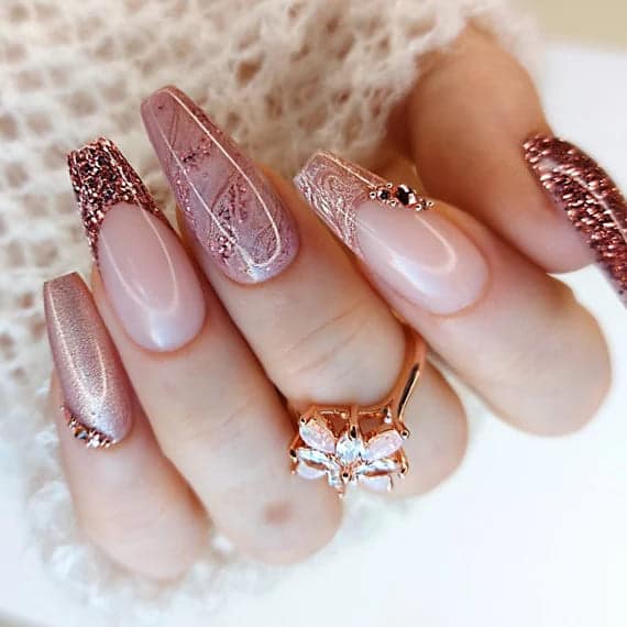 glitetry gold glam nails and ring on a finger