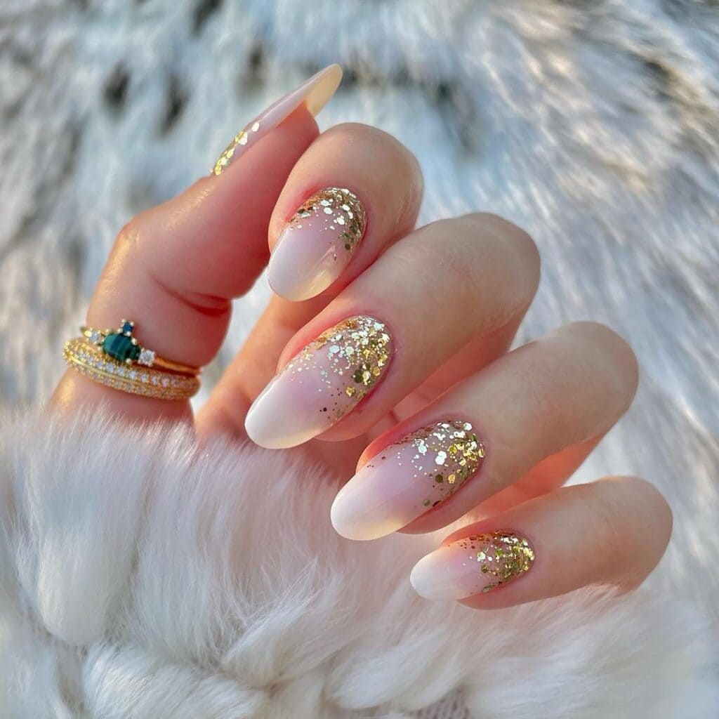 pink and golden ombre nails with rings on hands thumb x