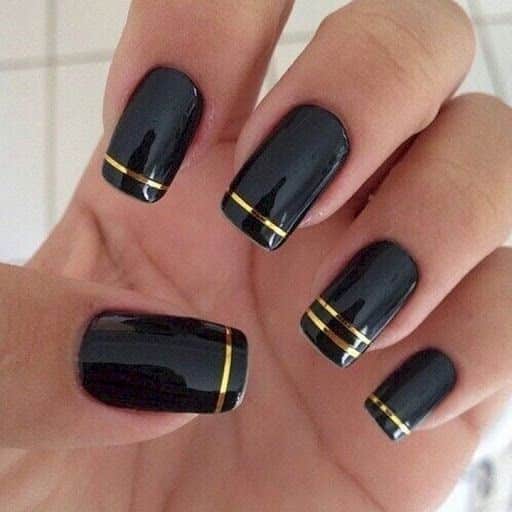 stripped nail art with black and golden color stripped nail art with black and golden color