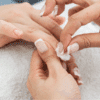 zoomed in view of girl's hands removing polygel nails