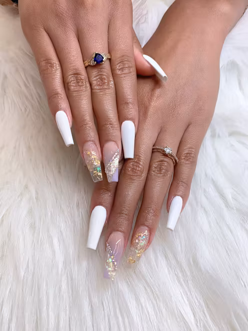 Hands with white nail color and glitter