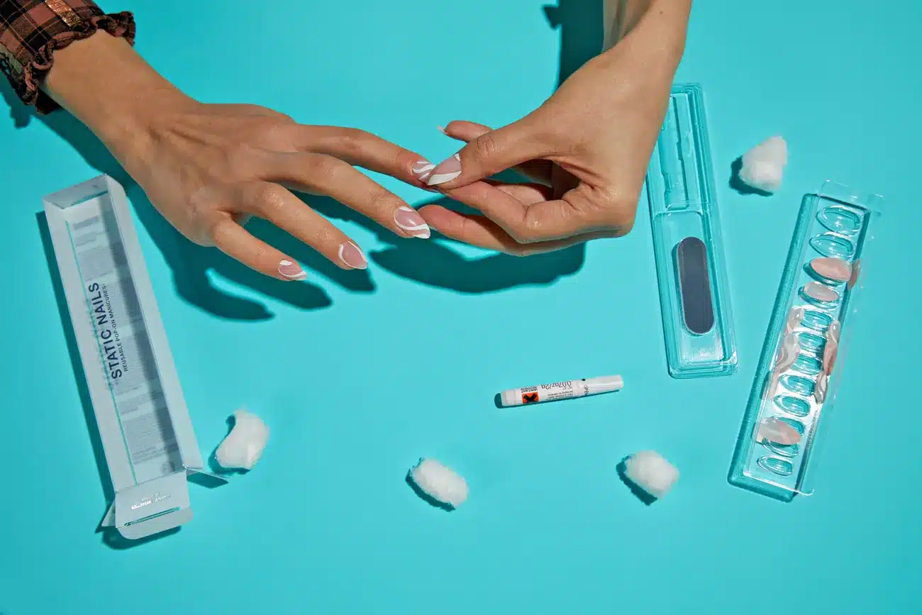 hands applying press on nails