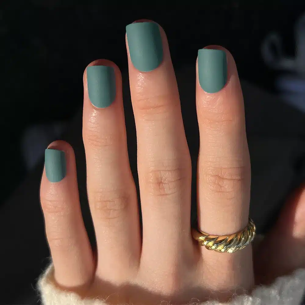 A view of matte teal nails A view of matte teal nails