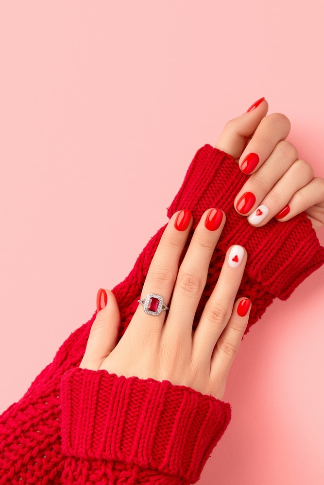 Manicured Womans Hands In Warm Wool Red Sweater 