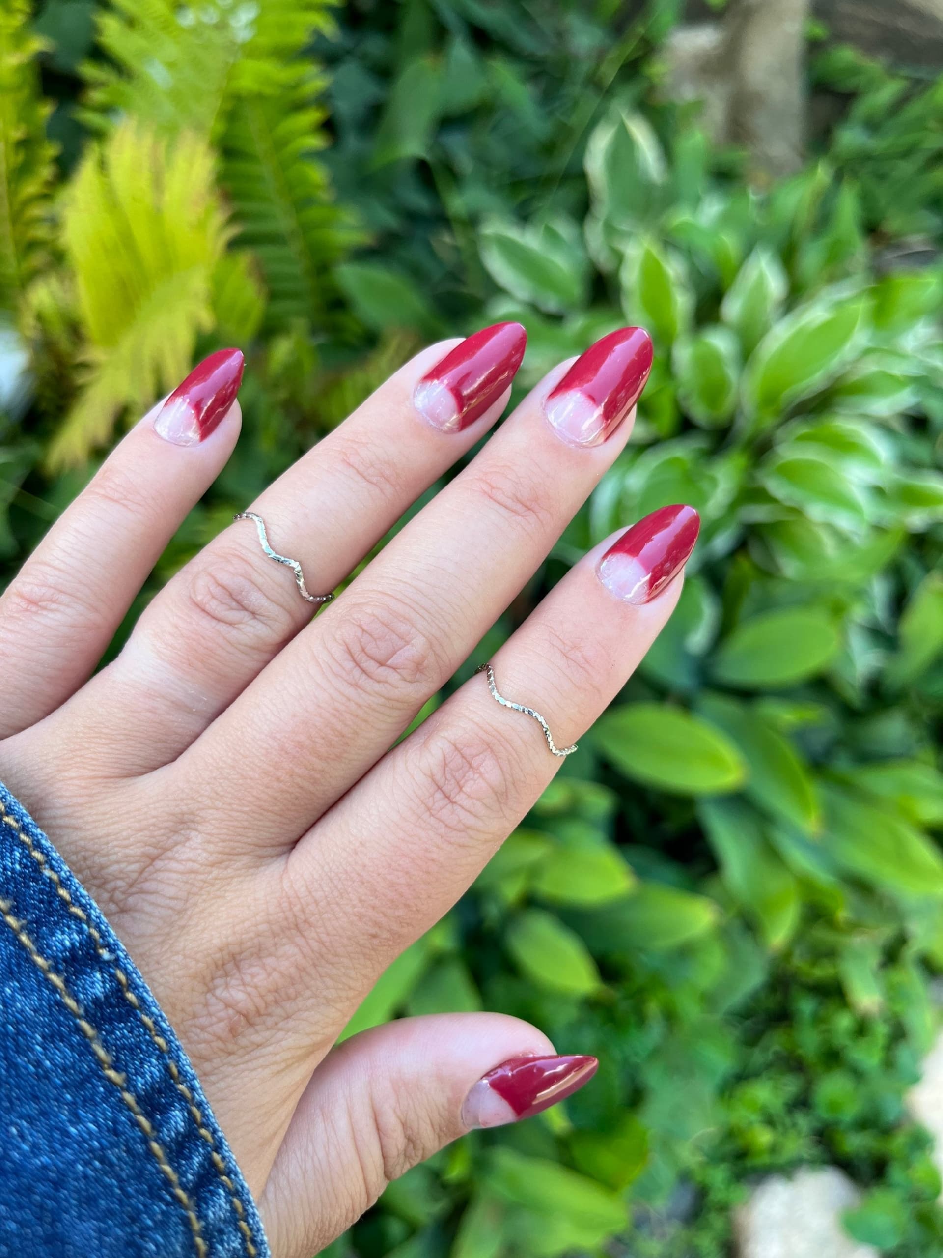 female hand with half moon pink and red nails