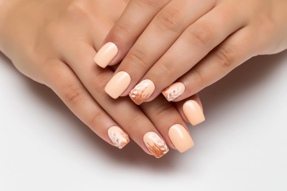 Peach Wedding Manicure With Gold Sequins And White Branches Leaves