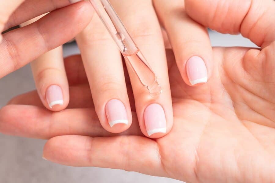 A view of clear nail color being applied on nails