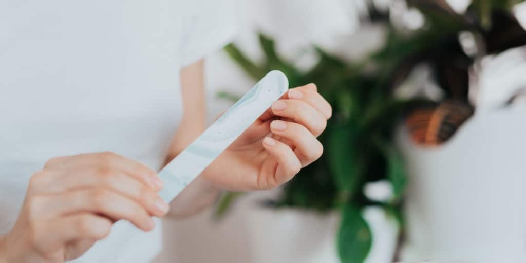 A view of a person using nail file on hands A view of a person using nail file on hands