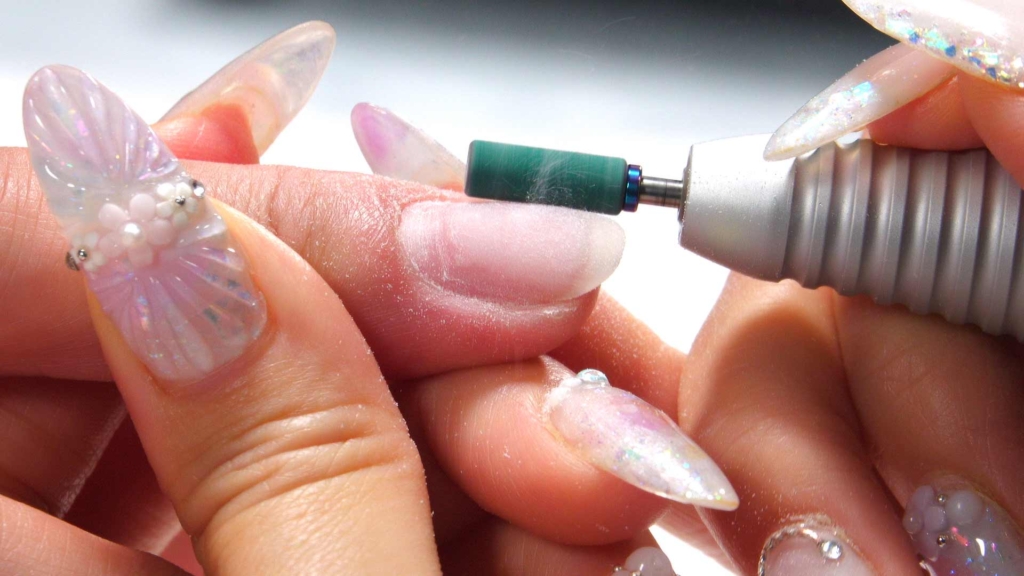 A view of an electric nail file being used on nails A view of an electric nail file being used on nails