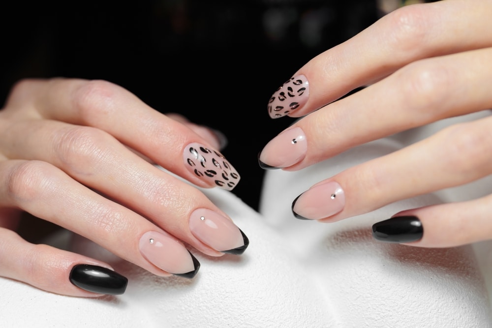 A view of hands with black tips manicure A view of hands with black tips manicure