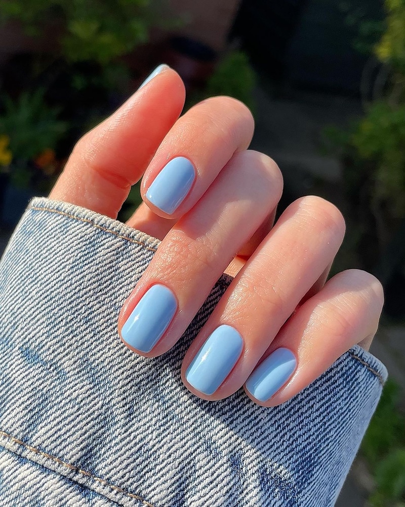 A view of a hand showing off blue nail color A view of a hand showing off blue nail color