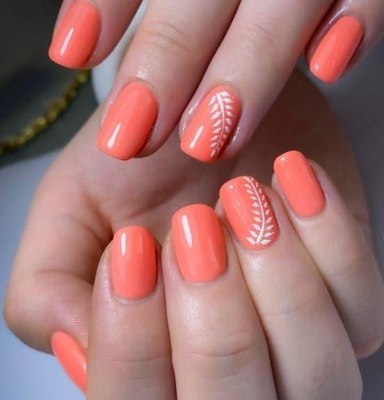 A view of coral nail paint on hands