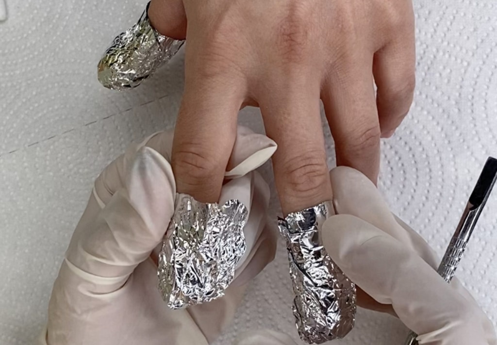 A view of nails in a foil for removal process