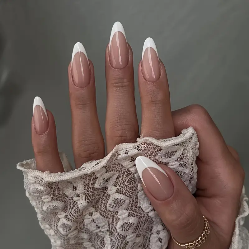 female hands with nude minimalistic nails Minimalist almond shaped nails with french tips
