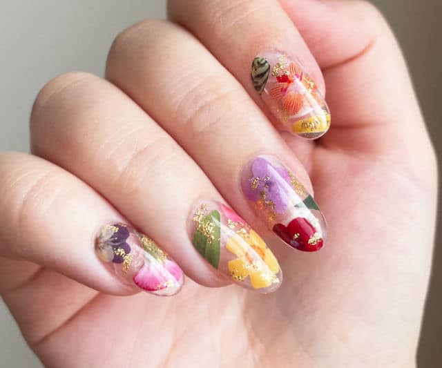 Pressed Flower Nails x female hand adorned with pressed flower nails