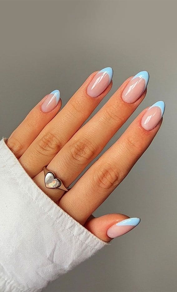 A hand showing light blue nail french tips A hand showing light blue nail french tips