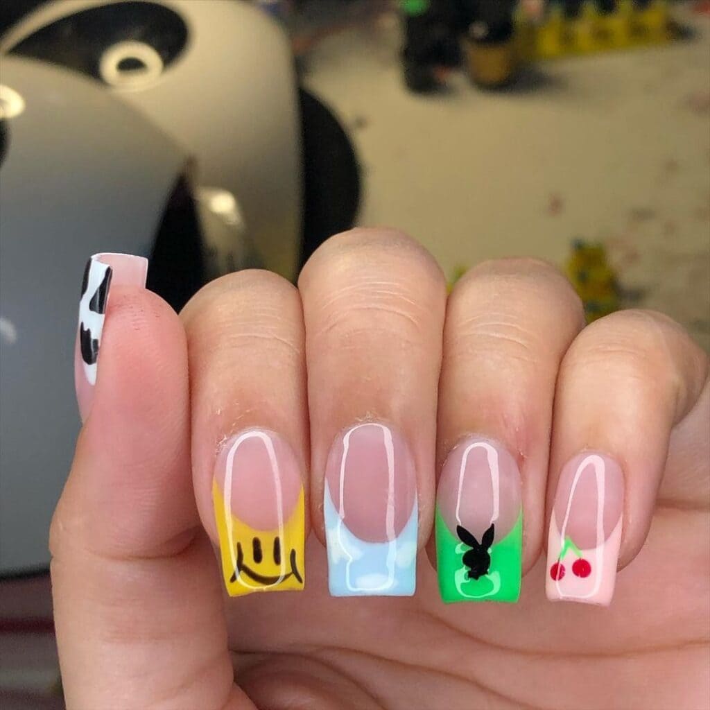 A hand showing off pop of color patterns on square nails x A hand showing off pop of color patterns on square nails x