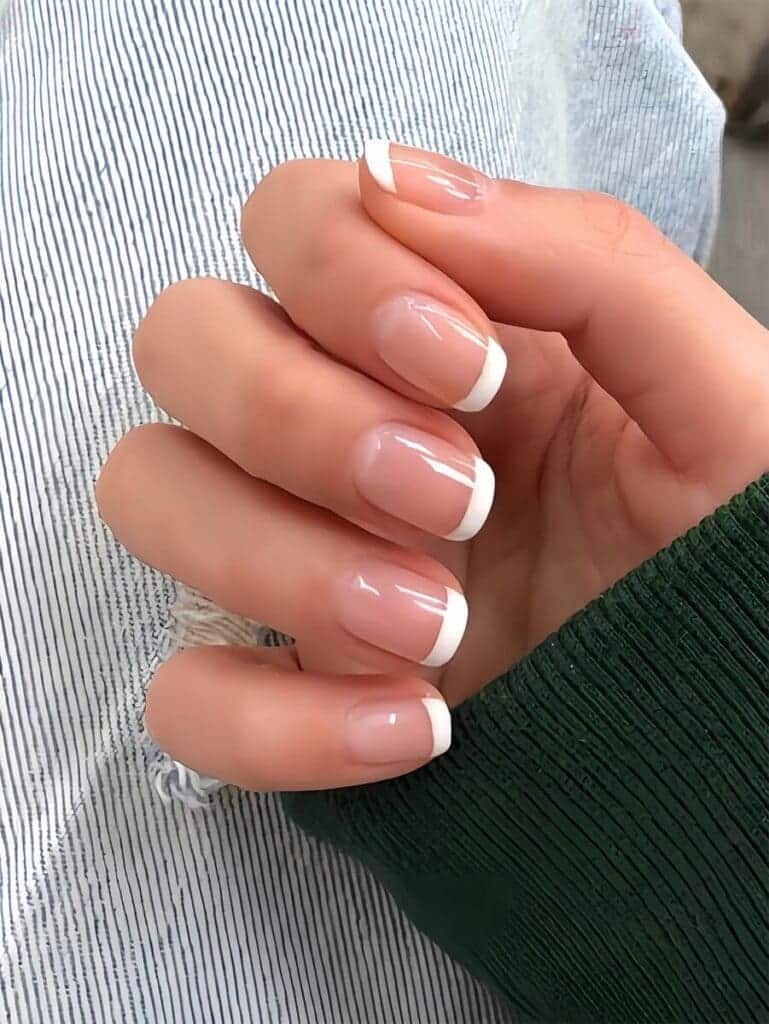 A hand with short french tips square nails x A hand with short french tips square nails x