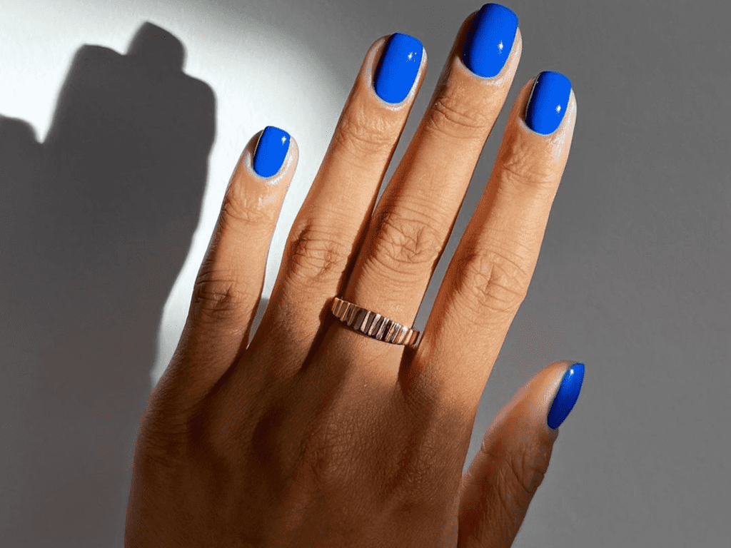 A view of hands with a ring with dark blue nail color x A view of hands with a ring with dark blue nail color x