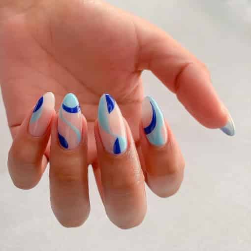 A view of nails showing shades of blue swirls A view of nails showing shades of blue swirls