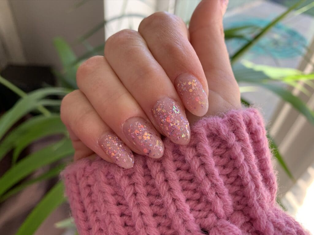 A view of pink glittery polygel nails x A view of pink glittery polygel nails x