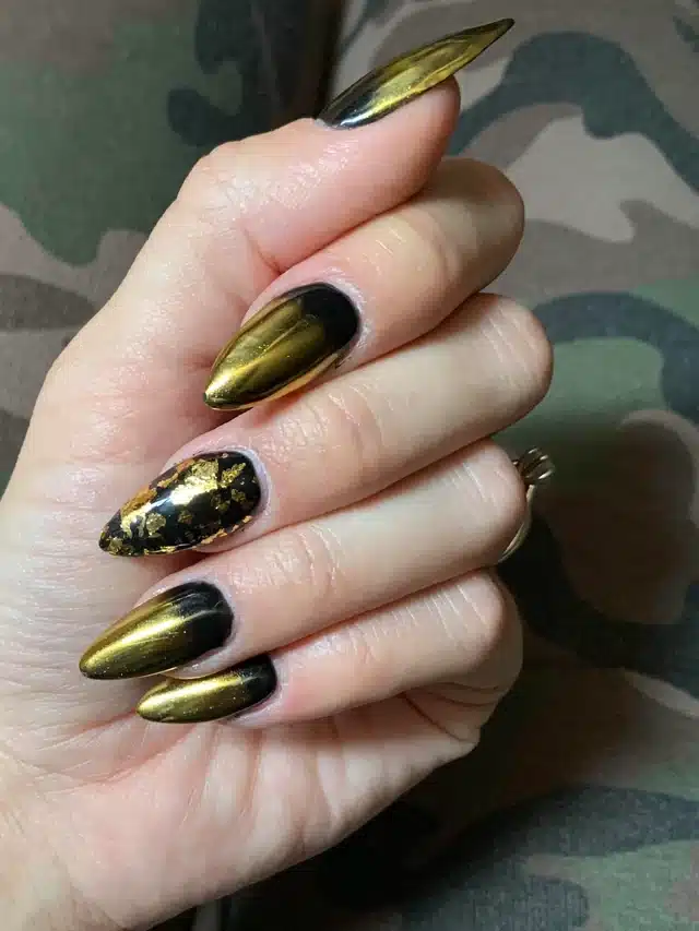 black nails with golden chrome accents black nails with golden chrome accents