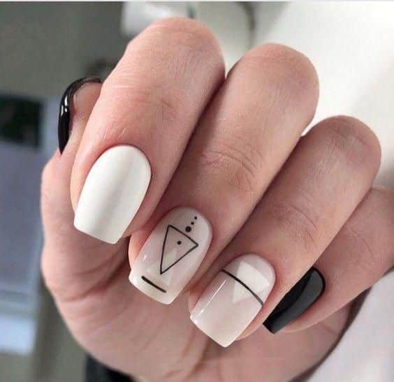 creamy white short square nails with black geometric designs creamy white short square nails with black geometric designs