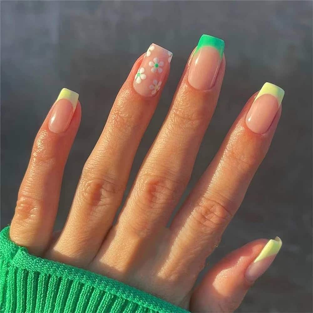 french nails with neon yellow and green tips one accent nail with white flowers french nails with neon yellow and green tips one accent nail with white flowers