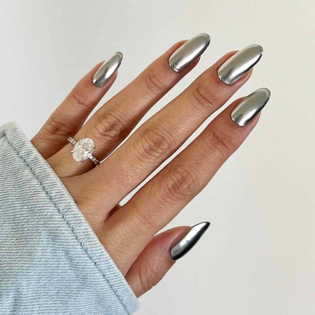girls hand with titanium chrome nails ring in her finger x girls hand with titanium chrome nails ring in her finger x