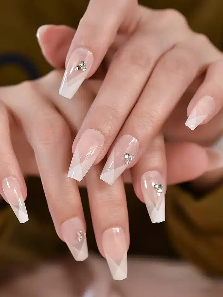 long clear nails with geometric deisgns and rhinestones long clear nails with geometric deisgns and rhinestones