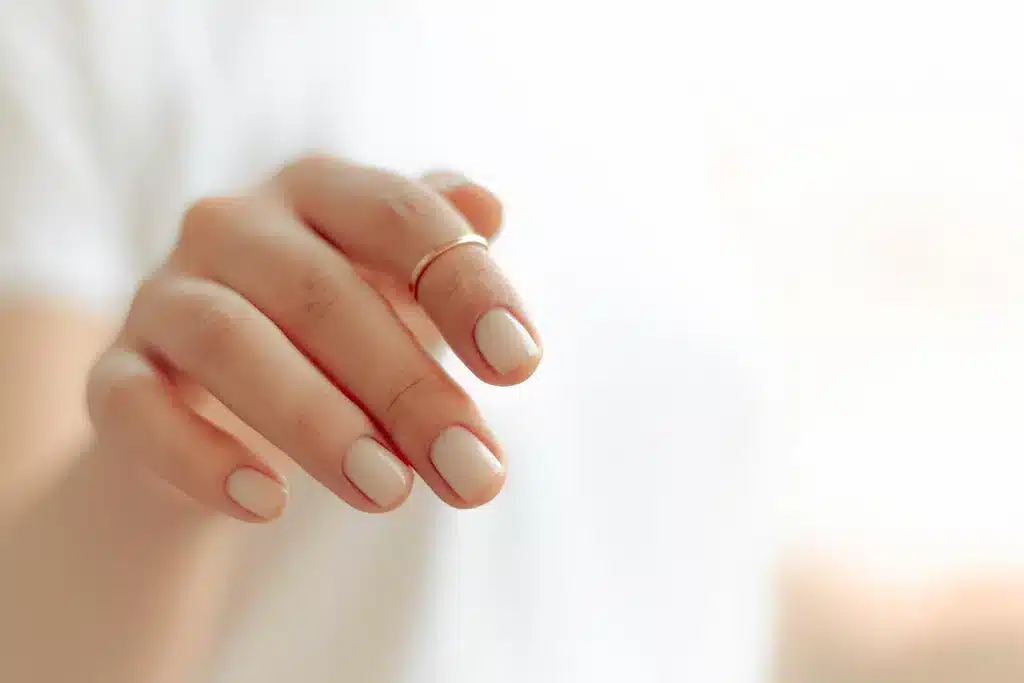 A view of nails with white top coat layering ( ) A view of nails with white top coat layering ( )