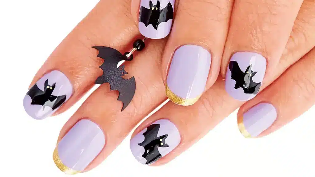 zoomed view of female nails with bat patterns zoomed view of female nails with bat patterns