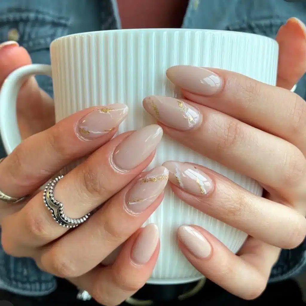 A view of hands holding a cup nude marble nails A view of hands holding a cup nude marble nails